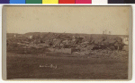 This large building was completely destroyed. Roof timbers are broken and laying on a pile of loose bricks. The caption reads "Machine Shop". 