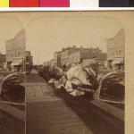 The tin from the roof of the Heaney Block was rolled up and dropped on the street by the force of the tornado. Just to the left (south) is the Cook House, built in 1869. The Heaney Block was built by Daniel Heaney in 1866. It was in this building, on the 3rd floor, where Dr. William W. Mayo set up temporary hospital for the care of those injured in the tornado. 