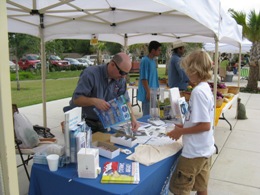 NWS Brownsville staffing a table at the weekly Brownsville Farmer's Market (Click for larger image)