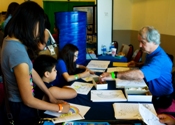 Buddy Martin working with children to draw clouds and storms (click to enlarge)