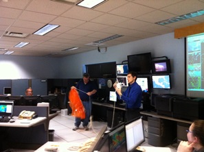 Doug Butts and Tim Speece describe how a radiosonde measures temperature, humidity, pressure, and winds and transmits information back to the office during tour by Brownsville Chamber of Commerce