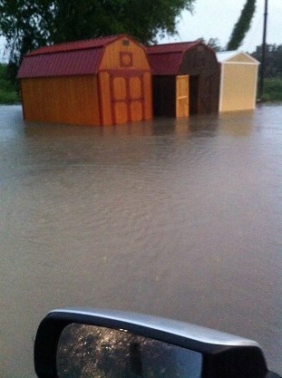 Standing water estimated one to two feet deep at outbuildings on a property in Hebbronville, Texas, just before sunset on June 17, 2015