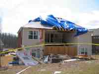 [ Damage to back of home in Brookmont subdivision. ]