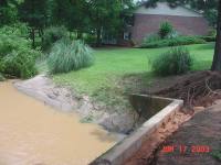 [ Water in this stream bed reached the building in the background ]