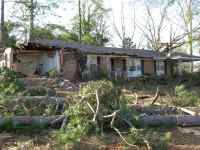 [ another view of severely damaged house ]