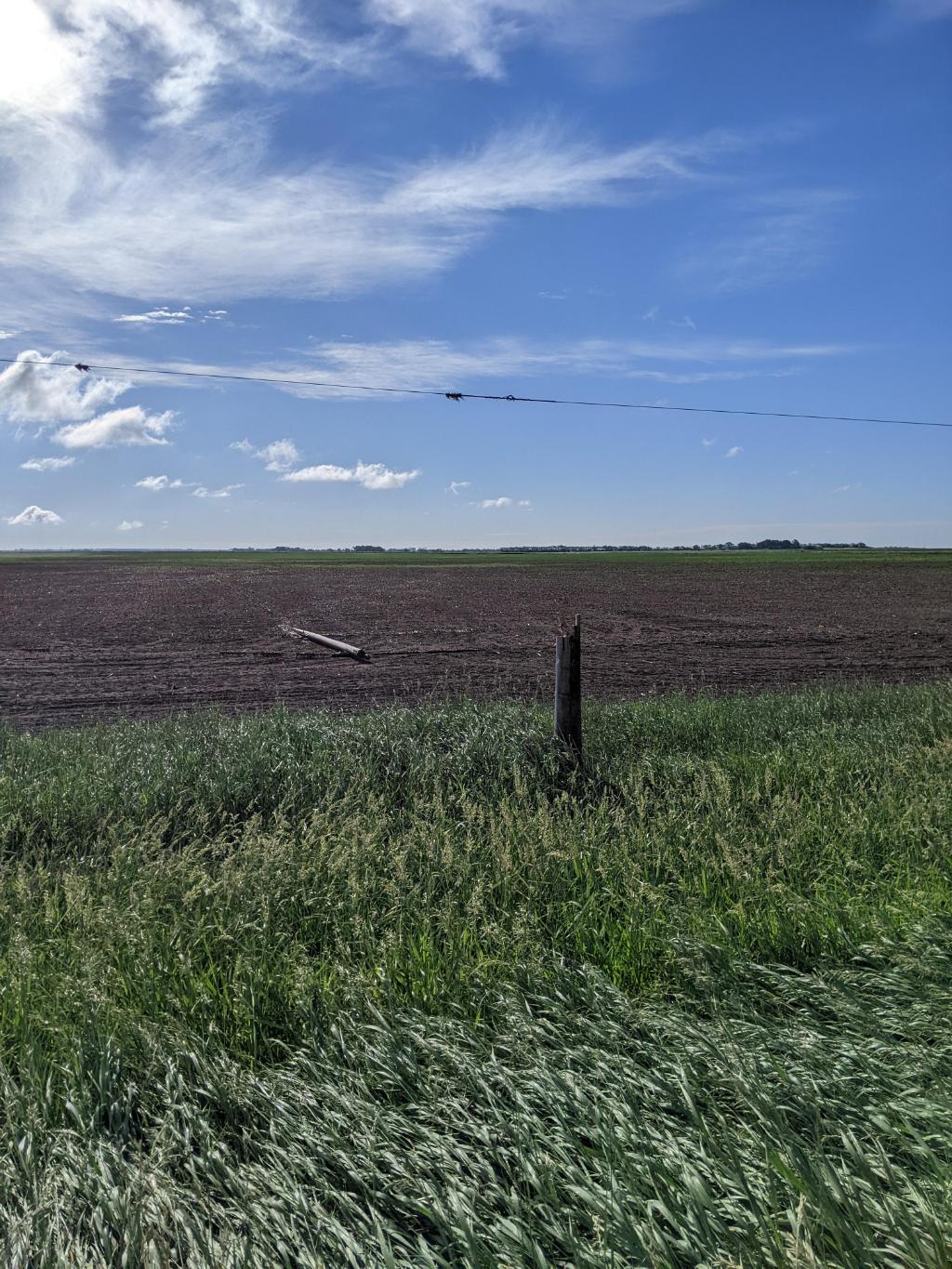 Power pole snapped by brief tornado north of Iroquois in far eastern Beadle County.