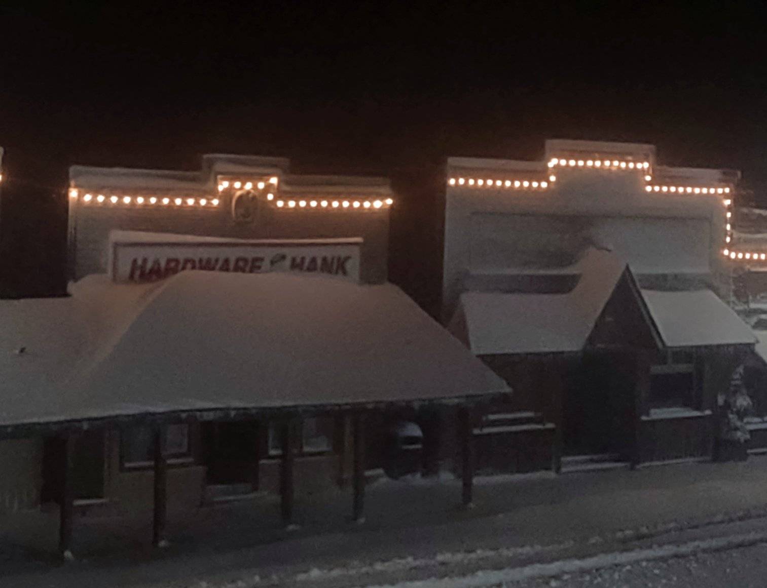 Store front awnings with lots of snow drifted up on them. 