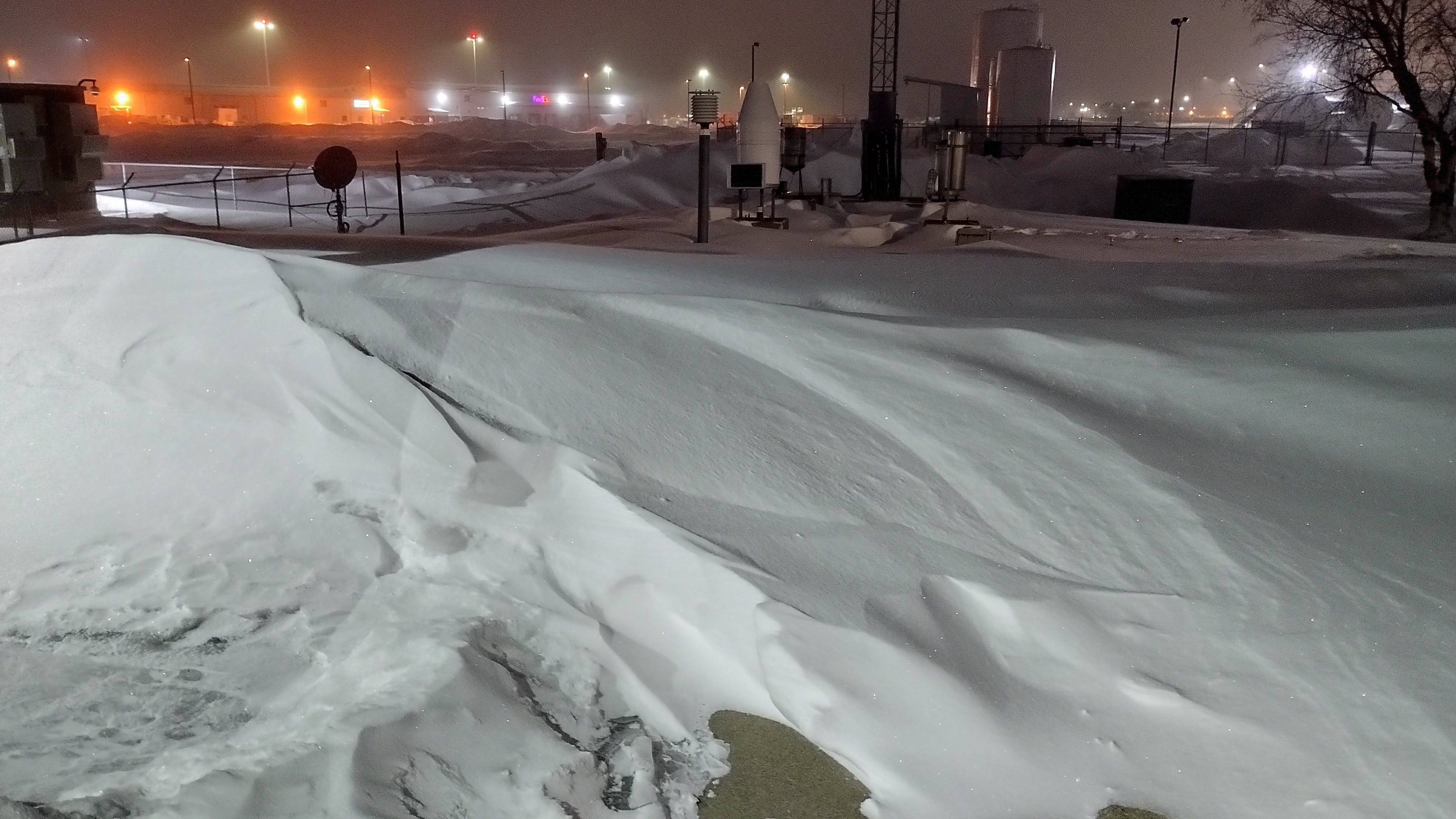 Deep drifts blocking the patch to the instrument cluster at NWS Sioux Falls following the blizzard.