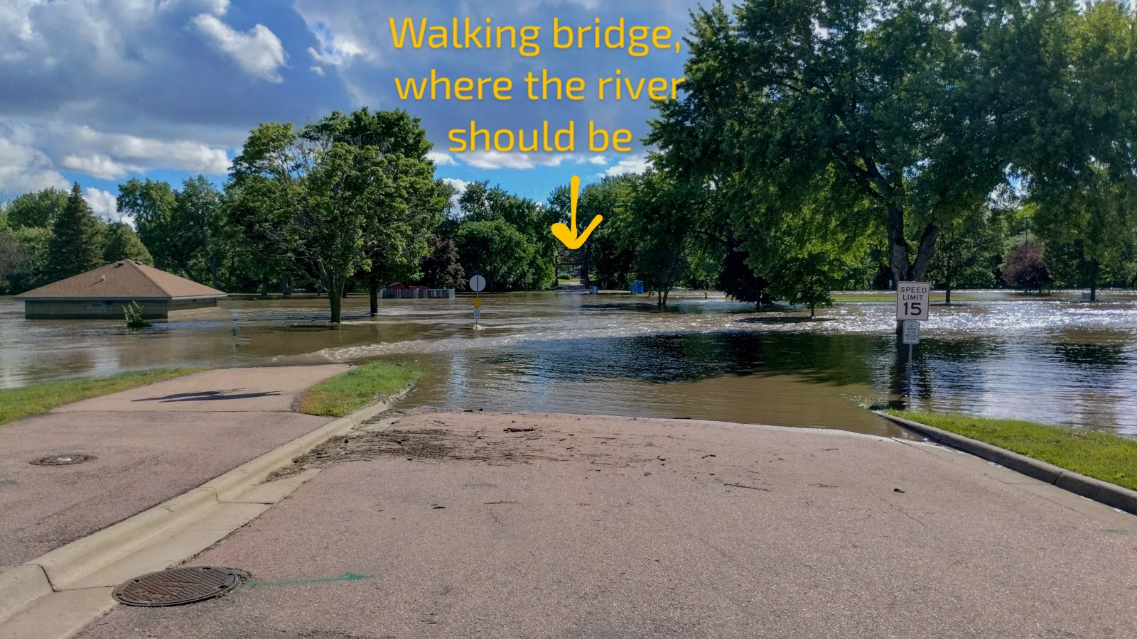 Photo of river flooding at the entrance to Cherry Rock Park in eastern Sioux Falls SD