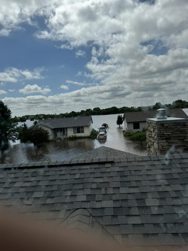 Photo of flood waters taken from the roof of a house. 