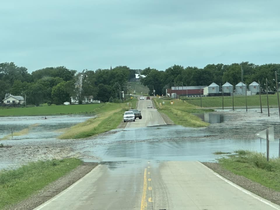 Photo of water flowing across a road at Struble Iowa