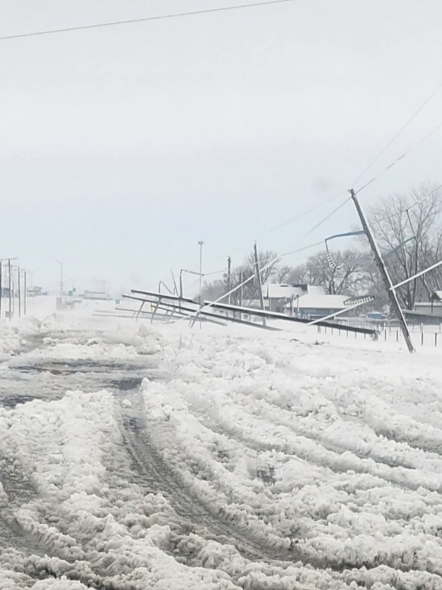 Photo of slushy snow on road and several power lines lying down