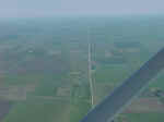 Aerial view of tornado path north of Manchester.  Tornado crosses road twice near center of image.