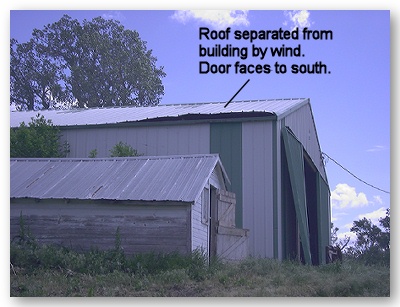 Photo of roof separated from building by wind. Door of building faces to south.