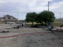 Roofing material blown into a parking lot