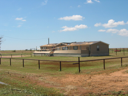 Image of a home damaged by severe thunderstorm winds.