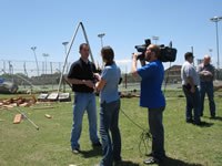 Brian LaMarre, NWS Lubbock Warning Coordination Meteorologist, conducts an interview to highlight damage survey information with ABC's KVII Amarillo News following a tornado impact in Childress, TX on May 10, 2006.