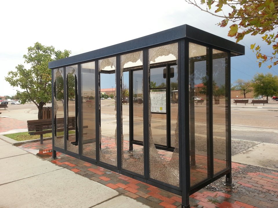 Photo of glass blown out at a bus stop on the Texas Tech campus