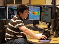 Forecaster working at an AWIPS workstation.