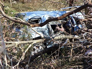 A car from the destroyed dealership in Mountain View (Stone County) was thrown over some professional buildings across the street and ended up in a ravine.