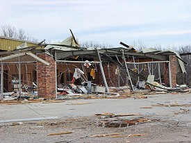 A vacant car dealership was heavily damaged.