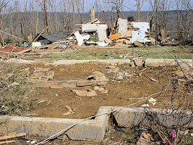 This house was blown off of its foundation and into some trees in the background.