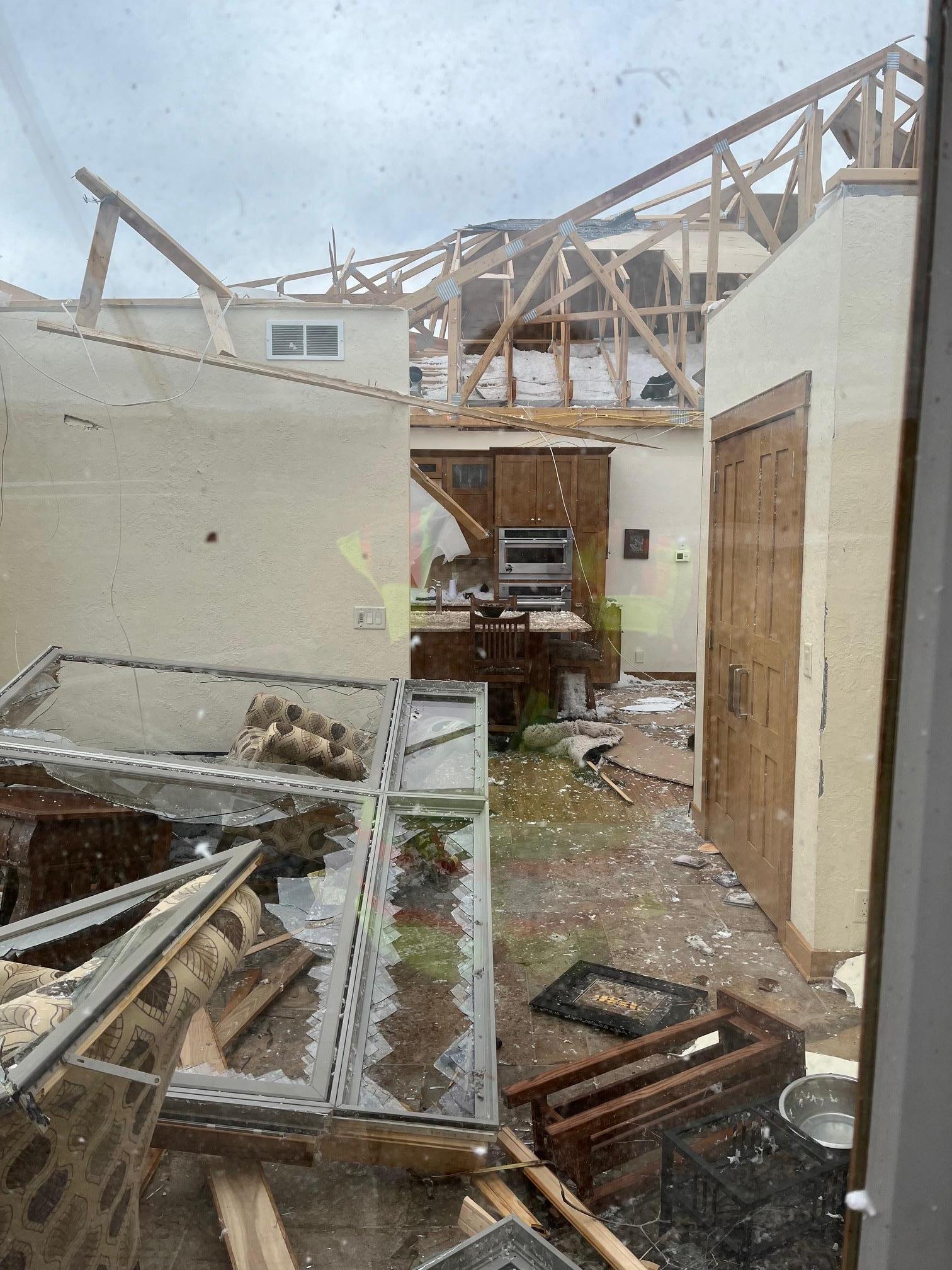 Roof blown off house with kitchen and living room exposed