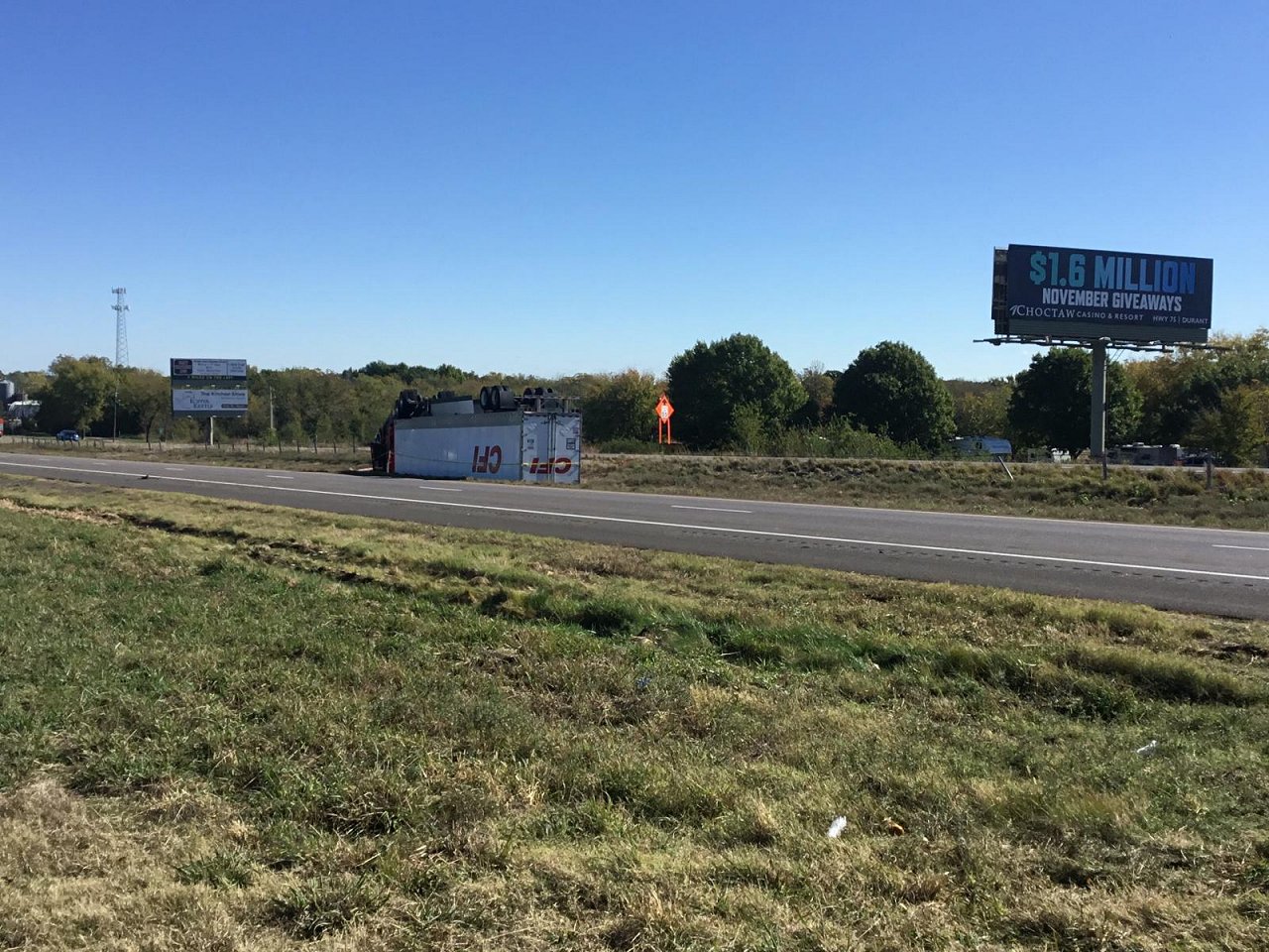 November 5, 2022 - Photo of overturned semi-truck and trailer near the northbound lanes of U.S. Highway 75 and southwest of Calera, OK