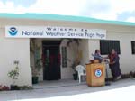 On behalf of NOAA/National Geodetic Survey, J. LaDouce presents plaque showing WSO Pago Pago coordinates to Leilua Mase Akapo