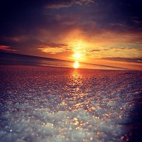 Ice covers a beach at sunset on Okaloos Island, FL. Photo submitted to NWS Mobile by Ama Wison via Twitter.