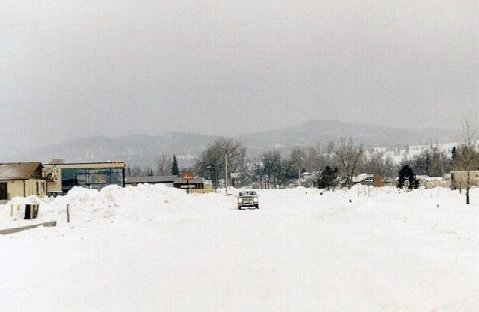 Looking south into the northern Black Hills from Spearfish. Dark clouds were forming along the leading edge of the higher terrain, and the release of moisture began just down wind as shown by the snow in the distance.