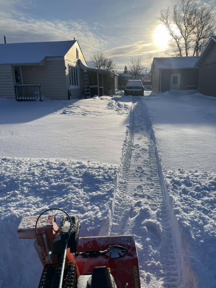 Shoveled path in heavy snowfall