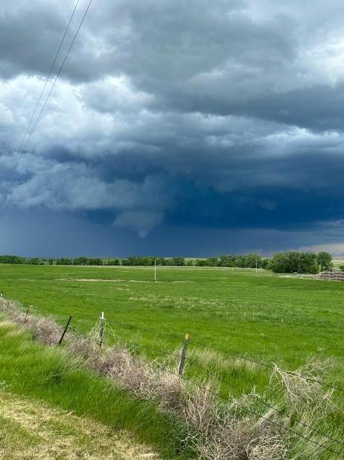 A storm produces a tornado that touches down in an open field near Faith, South Dakota