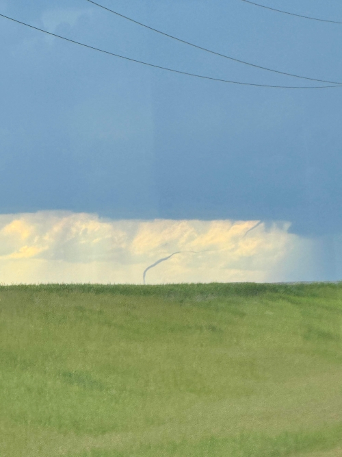 The tornado ropes out or dissipates over an open field near Faith, South Dakota